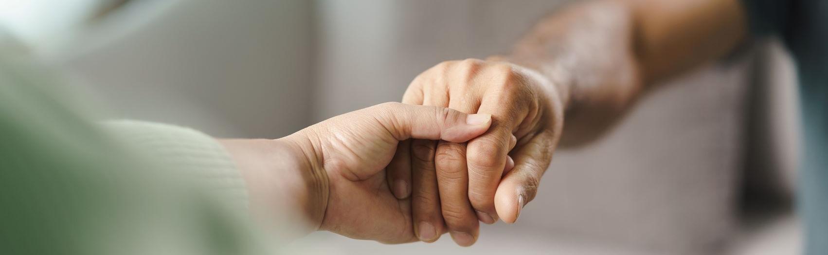 image of two people holding hands
